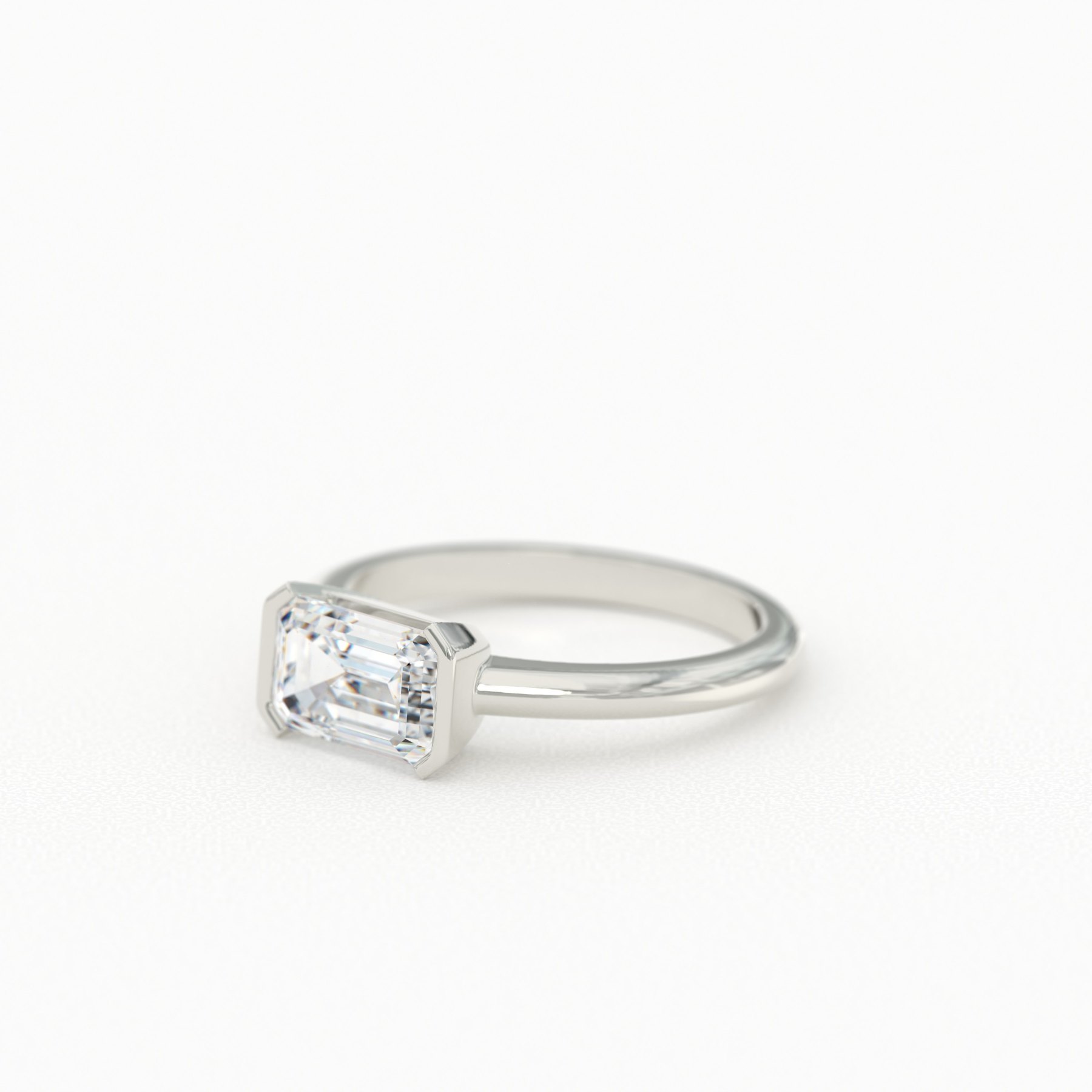 East-West Emerald Cut Solitaire with Half Bezel