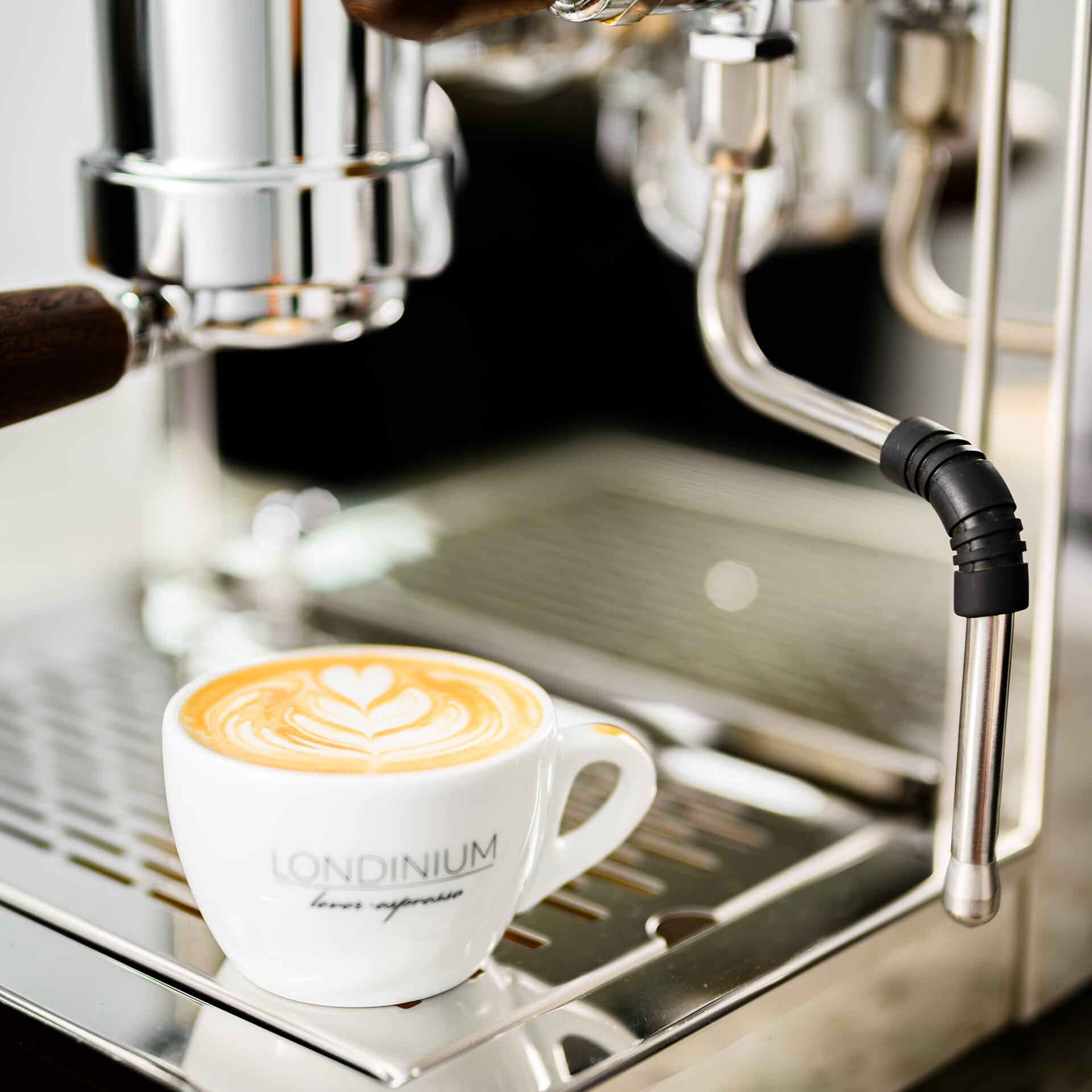 Londinium official close view of the current R24 steam wand beside a finished milk drink
